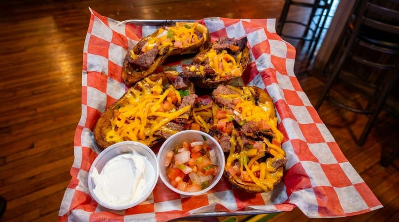 Four loaded potato skins with steak, cheese, and pico de gallo, served with sour cream.